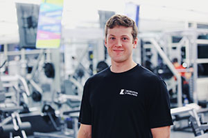 Michael Wicklein standing in front of weight lifting equipment