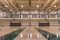 Two wood-floor indoor basketball courts side-by-side