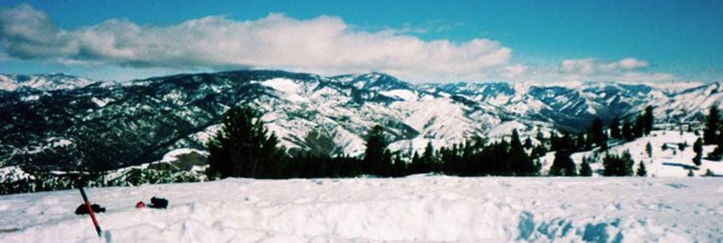 Snowcaps at the top of a vast mountain range on a sunny day. at the ski slopes