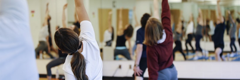 People in yoga poses in a yoga class