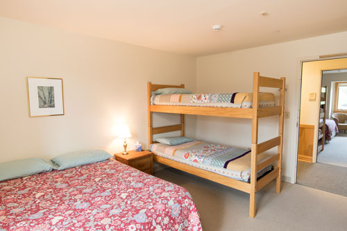 Pearly bedroom with full bed and twin beds