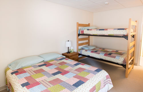 View of Wild Lupine room with full bed and bunk bed