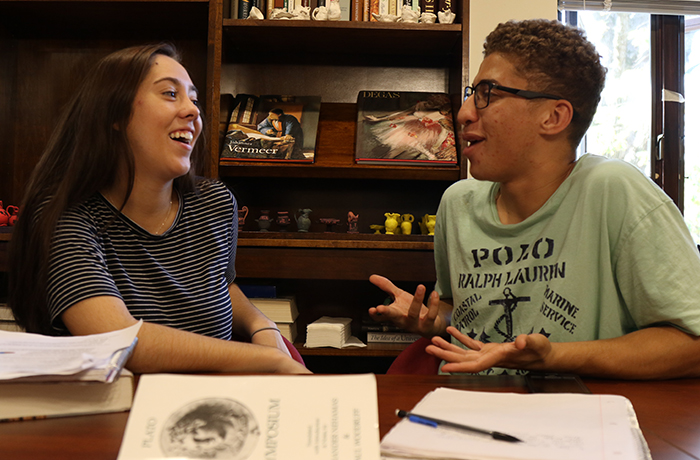 Two students speaking in a classroom