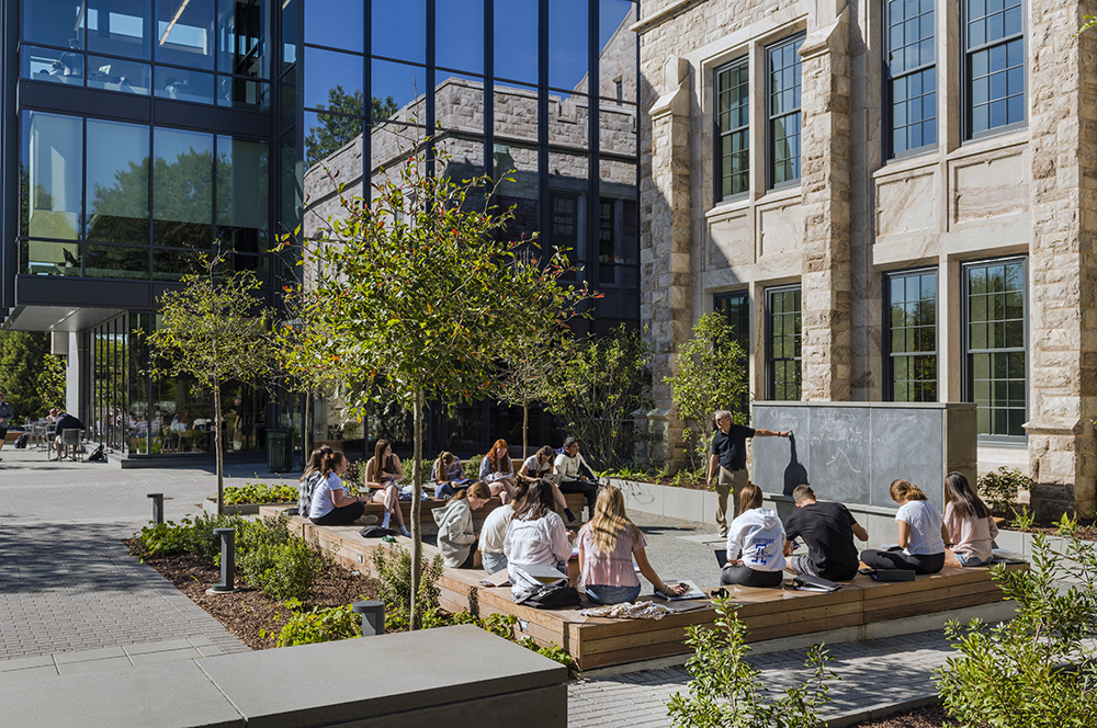 Outdoor classroom at Fernandez Building with teacher teaching class.