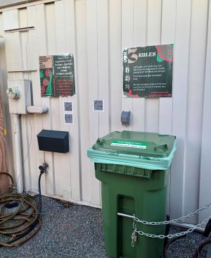 Photograph of the green Govans Community Compost Bin.