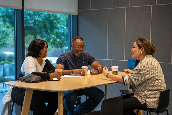 A family speaks with Loyola staff member