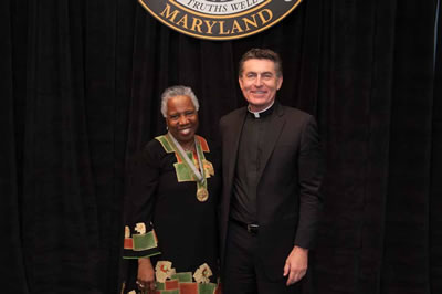 Linda Ellard Mouzon and Father Linnane
