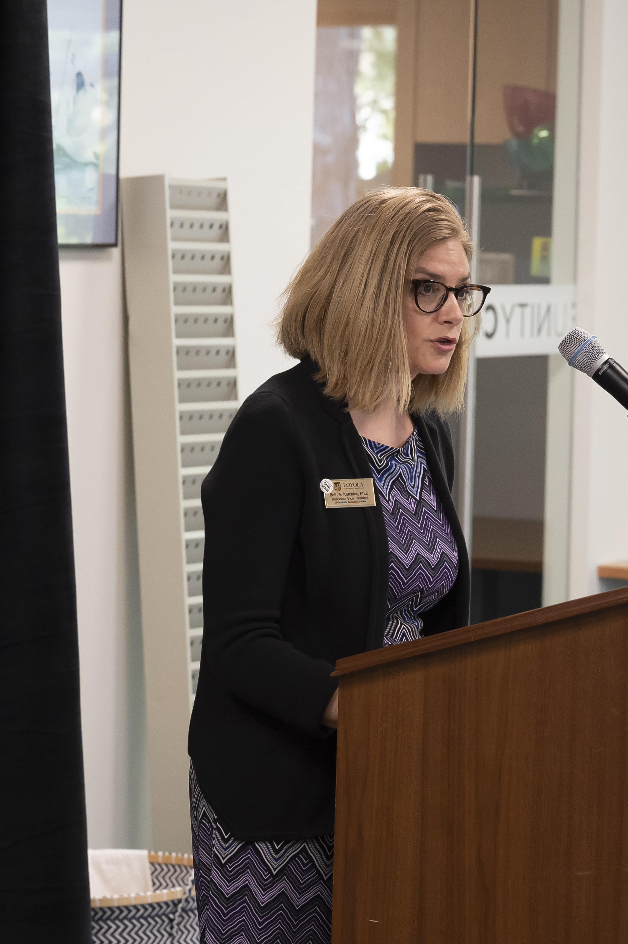 Administrator at podium at Emerging Scholars Celebration of Research, Loyola Univ. Maryland