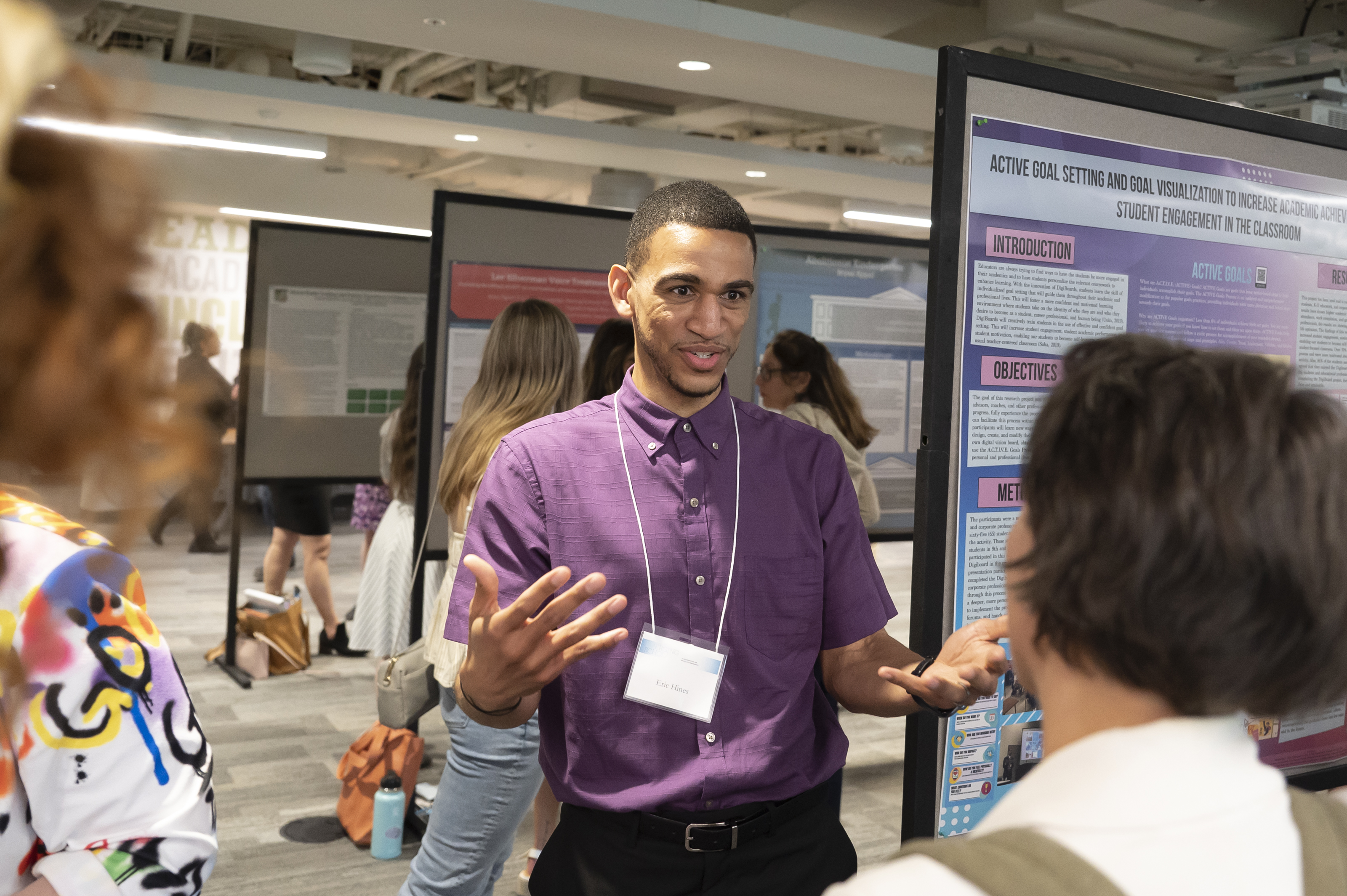 Presenter with outstretched hands at Emerging Scholars Celebration of Research, Loyola Univ. Maryland