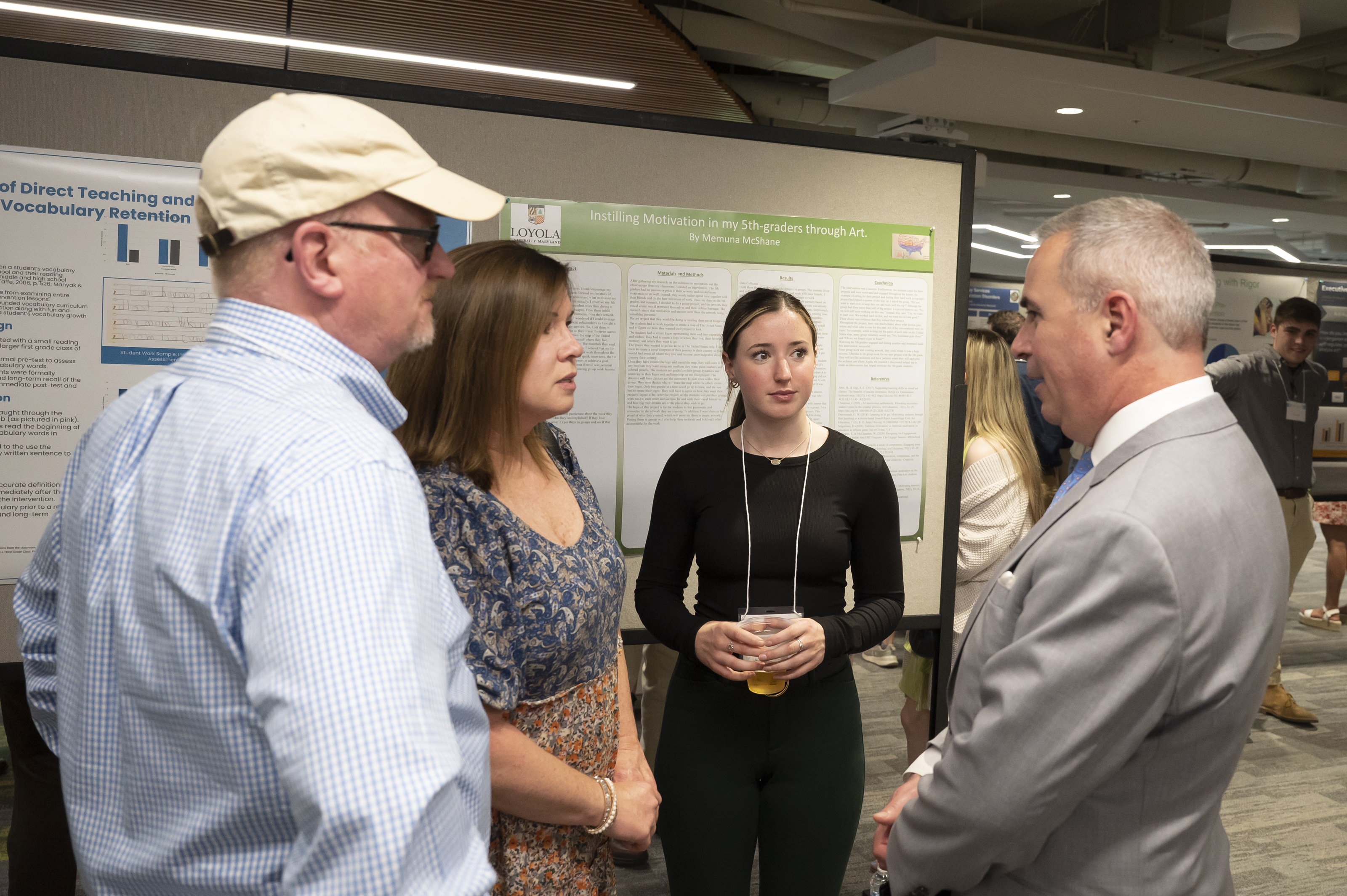 President Sawyer in discussion with presenter and family at Emerging Scholars Loyola University Maryland
