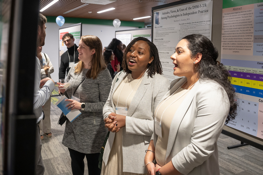 Presenters discuss poster at Emerging Scholars Loyola University Maryland
