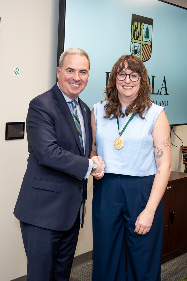 President Sawyer poses with awardee at Emerging Scholars Loyola University 2024