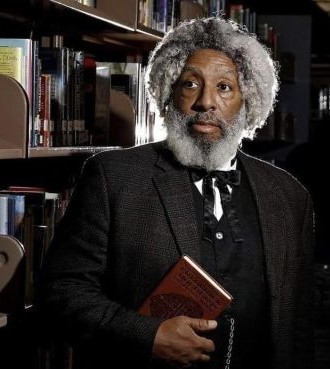 man in period costume in a library at night