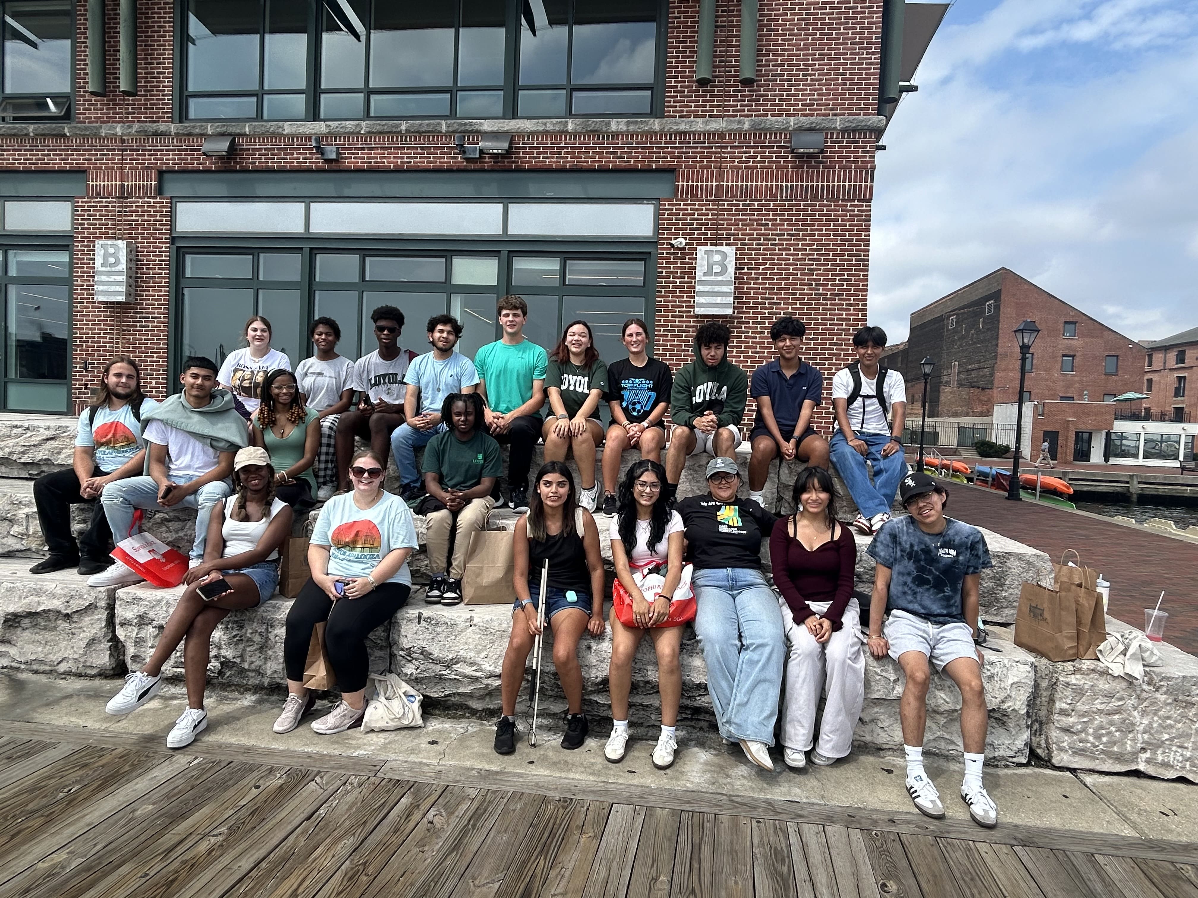 First-Generation college students sitting on stone benches in downtown Baltimore