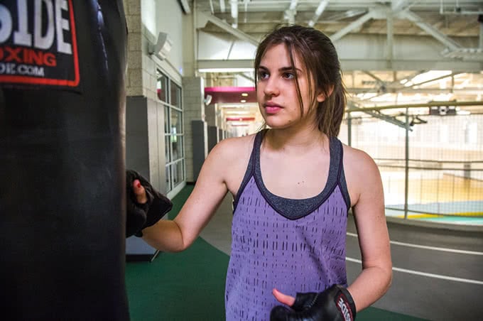 Student using punching bag