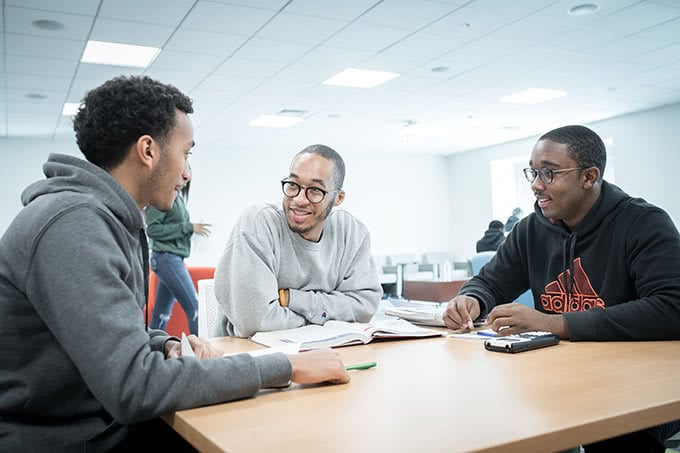 Students sitting around a table talking