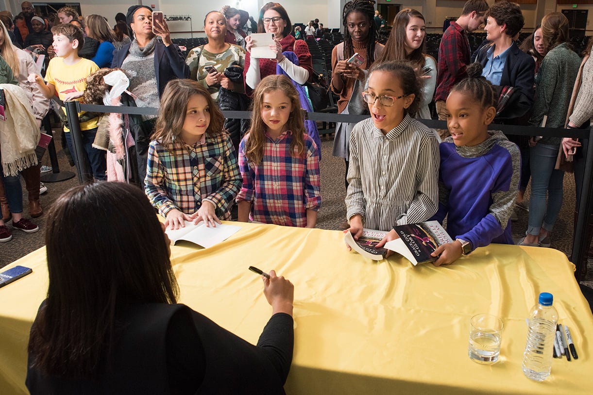 Young girls line up to have their books signed by Gabby Douglas