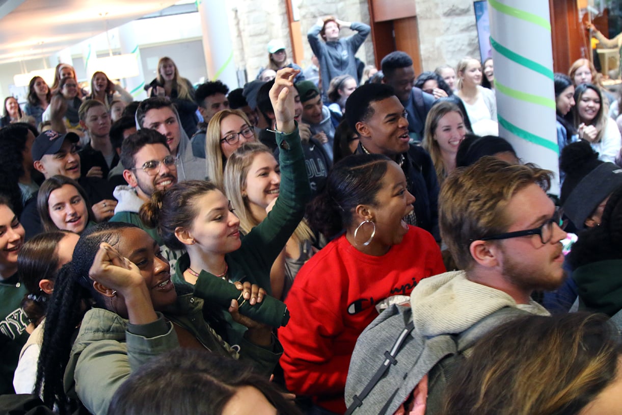 A large group of students cheering at a prep rally