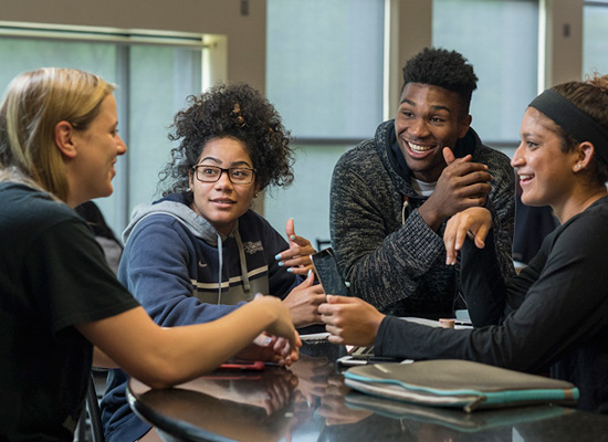 Students enjoying conversation together in a student lounge