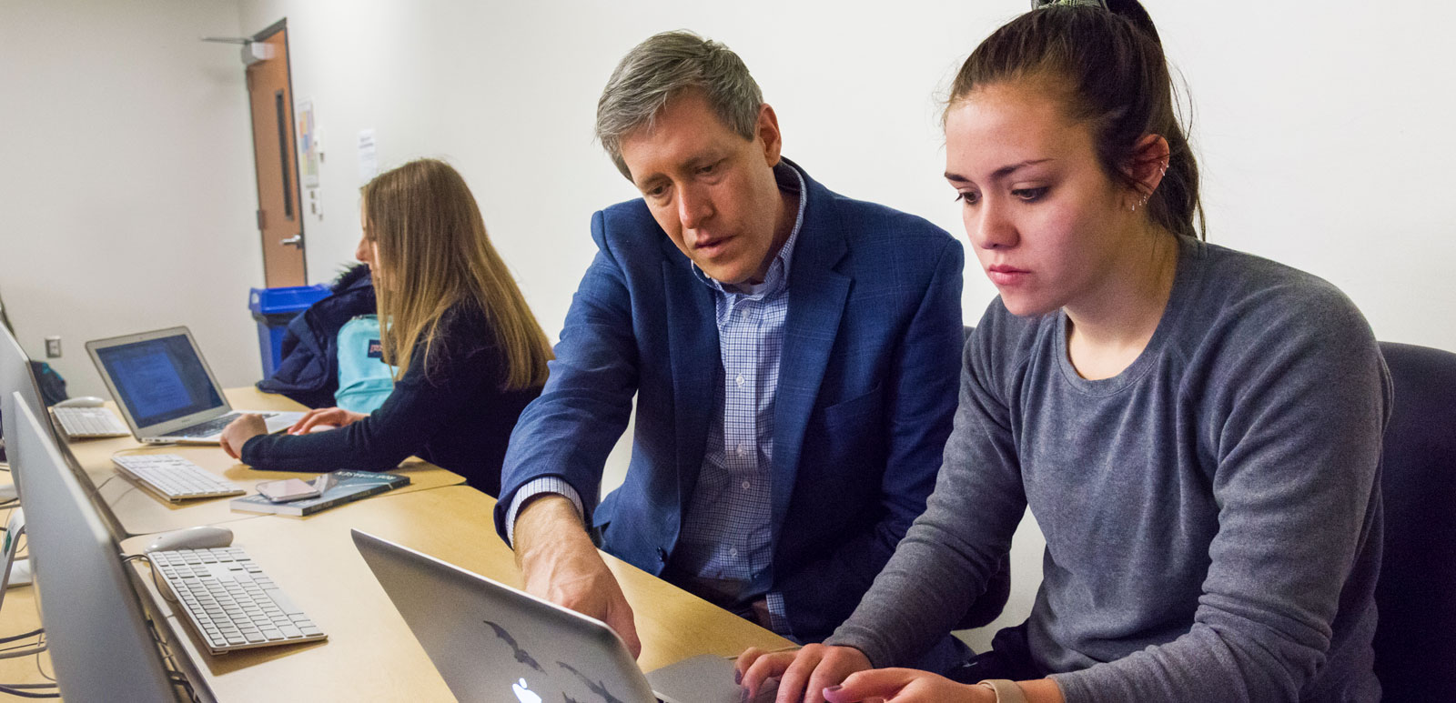 Professor Atticks advises a student on their book project.