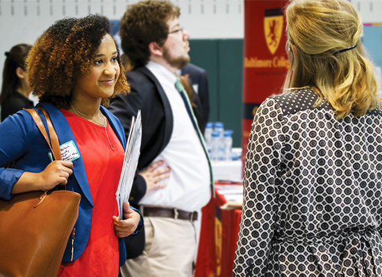 Student meeting an employer at a career fair