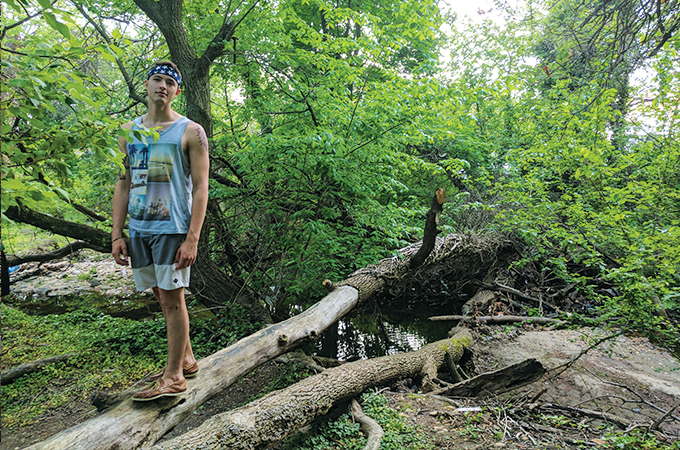 A student enjoys the lush greenery of the trail.