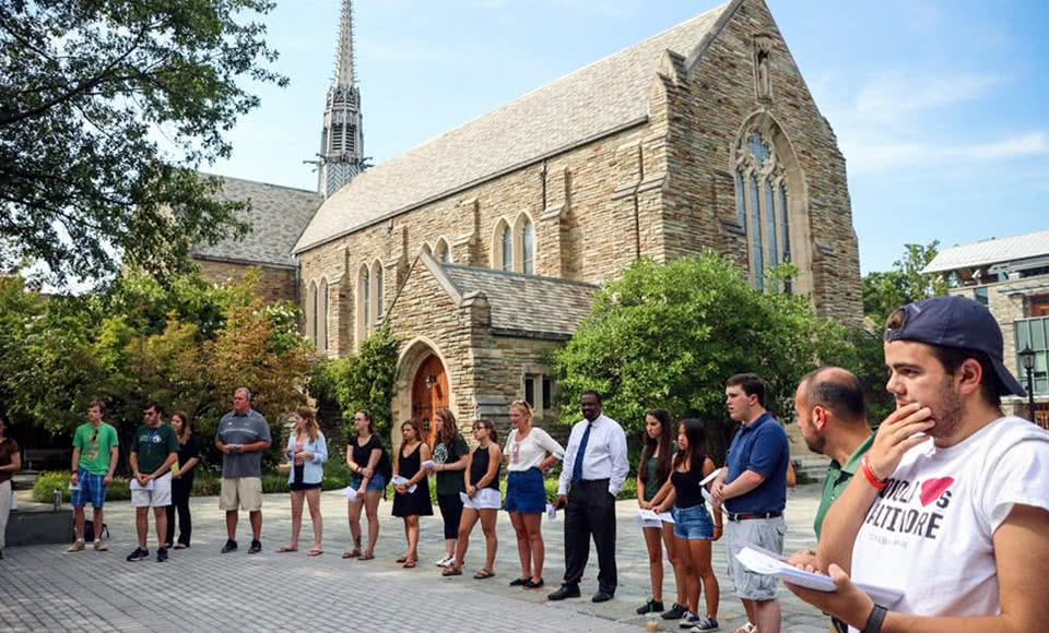 A crowd gathering for a mass outside the chapel