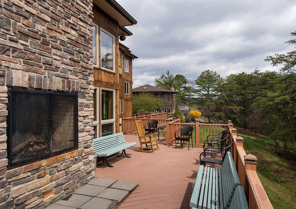 Back porch with a fireplace and seating