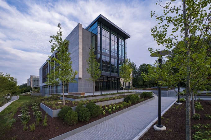 Photo showing the glass façade of the new Fernandez Center, attached to the former Beatty Hall