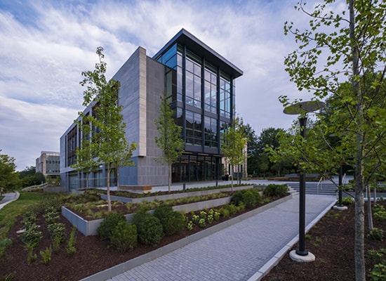 Photo showing the glass facade of the new Fernandez Center, attached to the former Beatty Hall