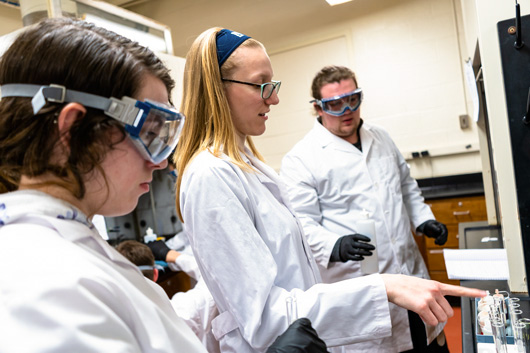 Hannah instructs students at various points of the lab.