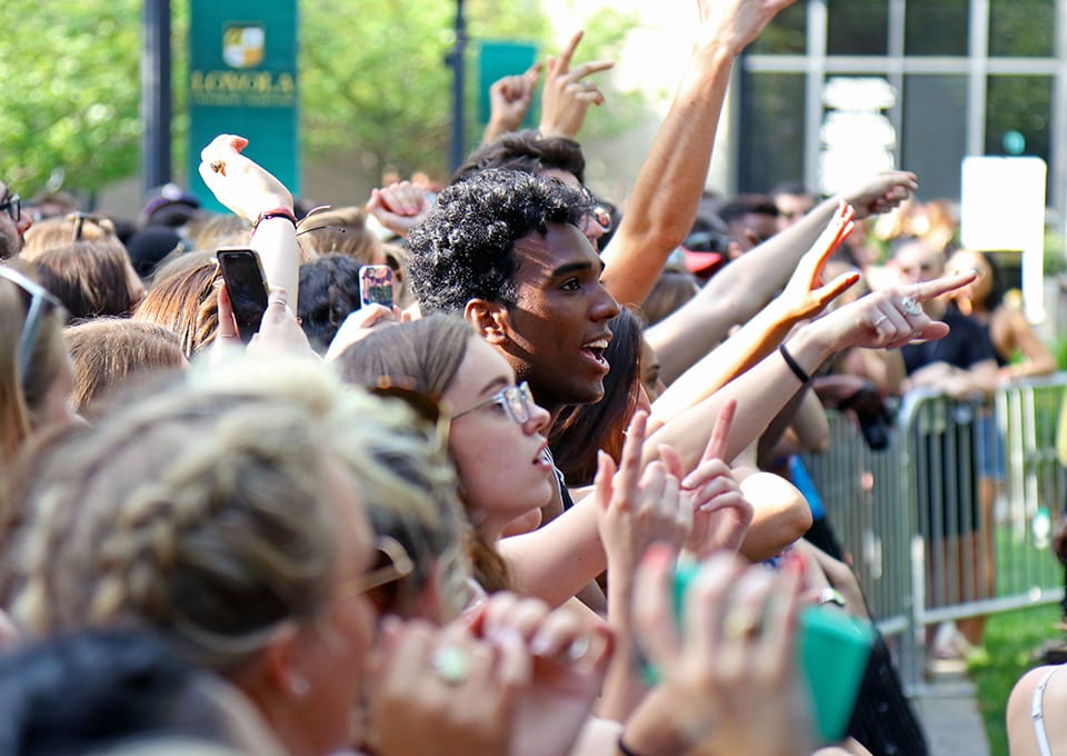 Side view of a crowd cheering