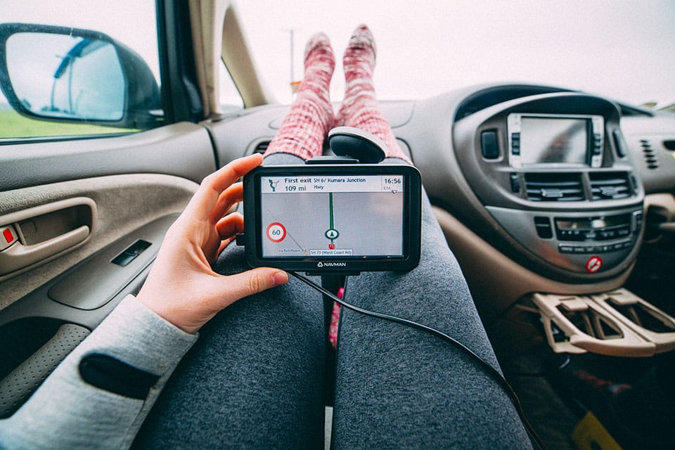 Feet up in the car while looking at a GPS