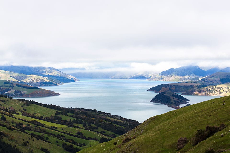 Overlooking the countryside with green hills surrounding a body of water