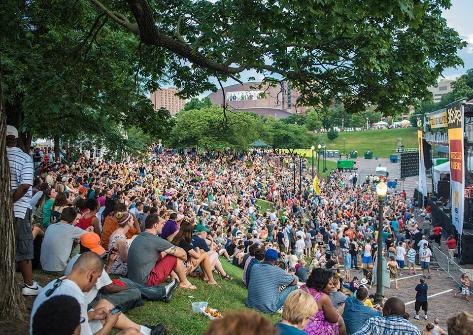 A crowd gathers on the lawn at Artscape