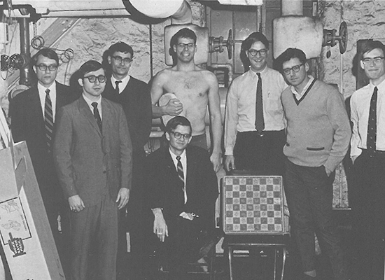 Black and white photo of Tom Clancy in the Student Center basement with his chess club mates.