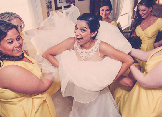 Bride surrounded by her bridesmaids.