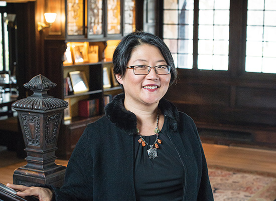 Jean Lee smiles by the humanities manor grand staircase.