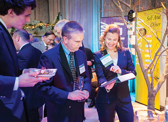 Carolyn Barry at an event, speaking with attendees.