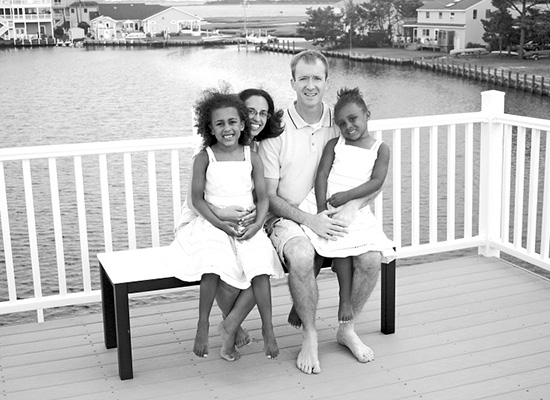 Radday family sits together on their porch pier.