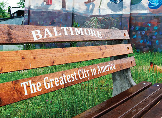 Baltimore City bench with mural in the background.