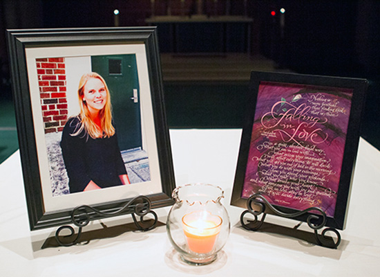 Memorial photo of Colleen with candle lit in front of frame.