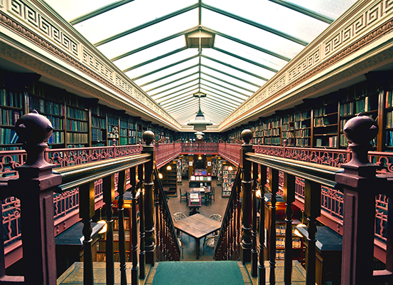 Photo of grand library interior as seen from above a staircase.