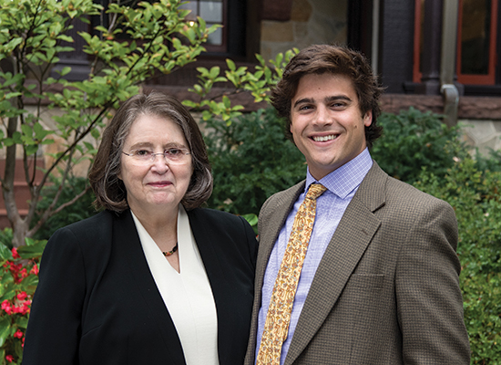 lona McGuiness, Ph.D., with Chris Miller, ’15, standing together near the humanities manor.