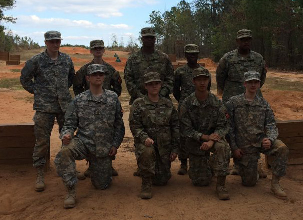 David Alexander amongst eight of his other army colleagues, all in full uniform.