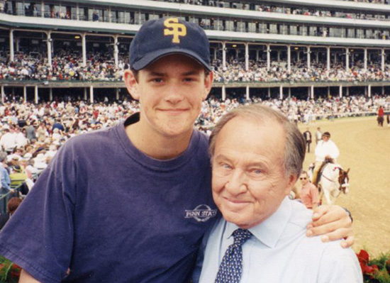 Picture of Jim with young man at a horse stadium.