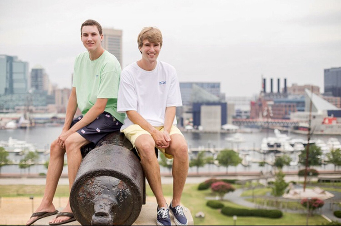 Matt and Kevin sit on a cannon at Federal Hill.