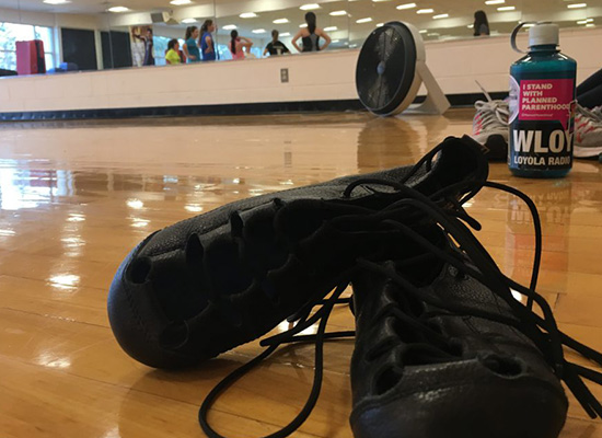 Dancer's shoes on the wooden dance room floor.