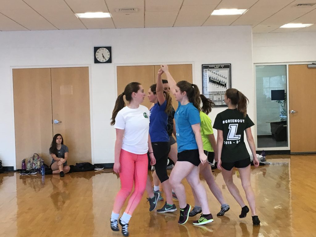 Students in a circle practicing Irish dancing