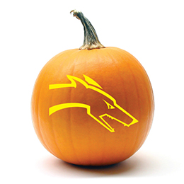 Pumpkin with a greyhound head carved in it